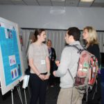 Meeting participants discussing poster presentations.